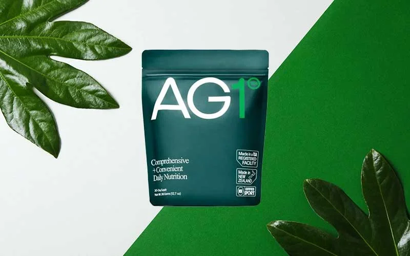 AG1 Athletic Greens Superfood Powder on green background