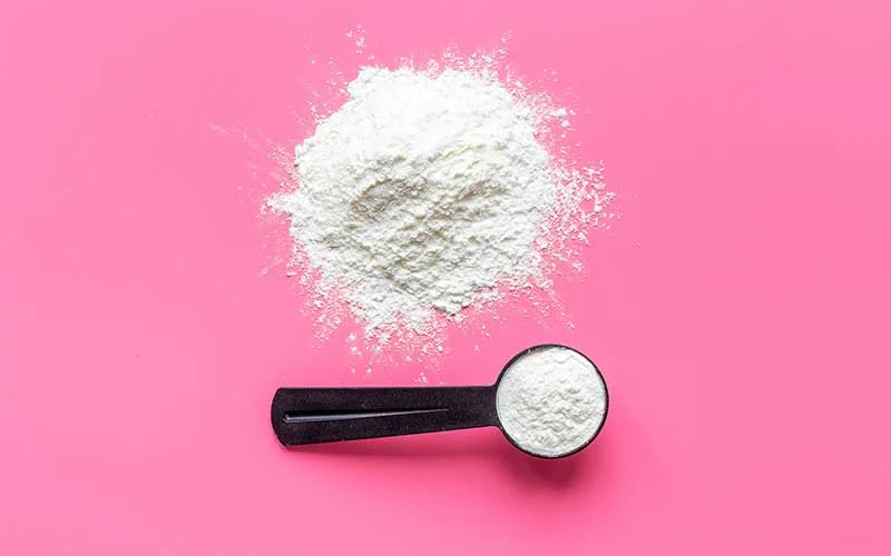 Collagen peptide powder in scoop