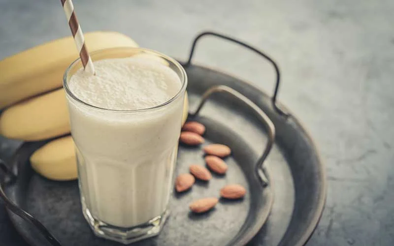 Banana Meal Replacement shake with almond milk in glass.