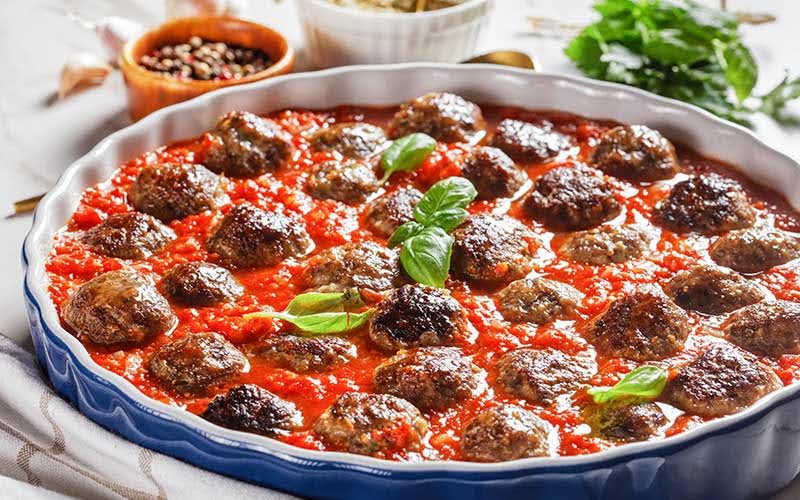 Keto meatballs with tomato sauce in a baking dish