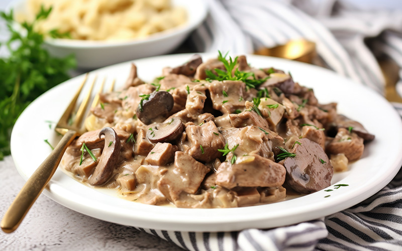 White plate with healthy keto beef stroganoff