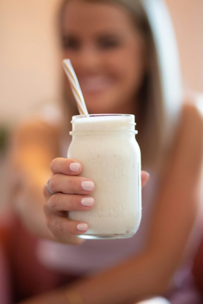 Woman Holding Vanilla Protein Shake