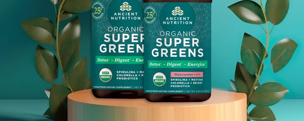 Ancient Nutrition SuperGreens Powder on leafy background