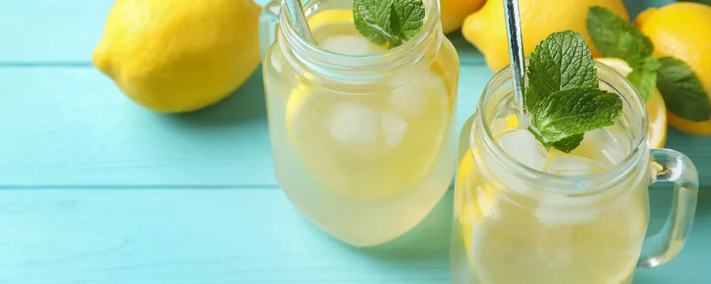 homemade lemonade with mint on light blue wooden table